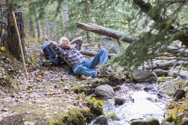 Caucasian hiker resting in forest