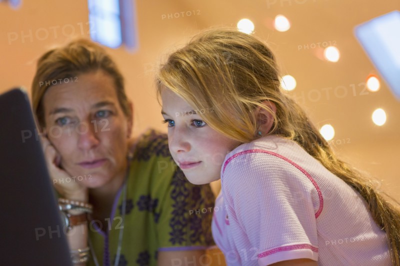 Caucasian mother and daughter using computer together