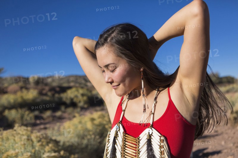 Mixed race woman standing in remote desert landscape