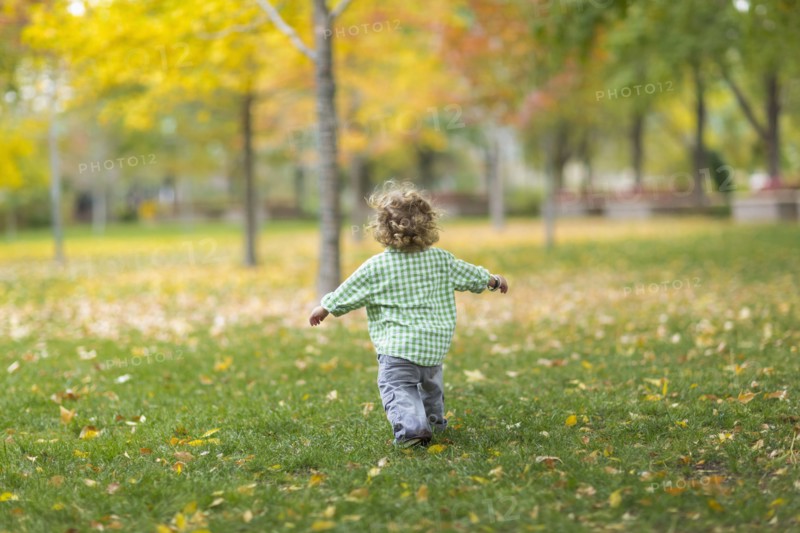 Caucasian boy running on grass lawn