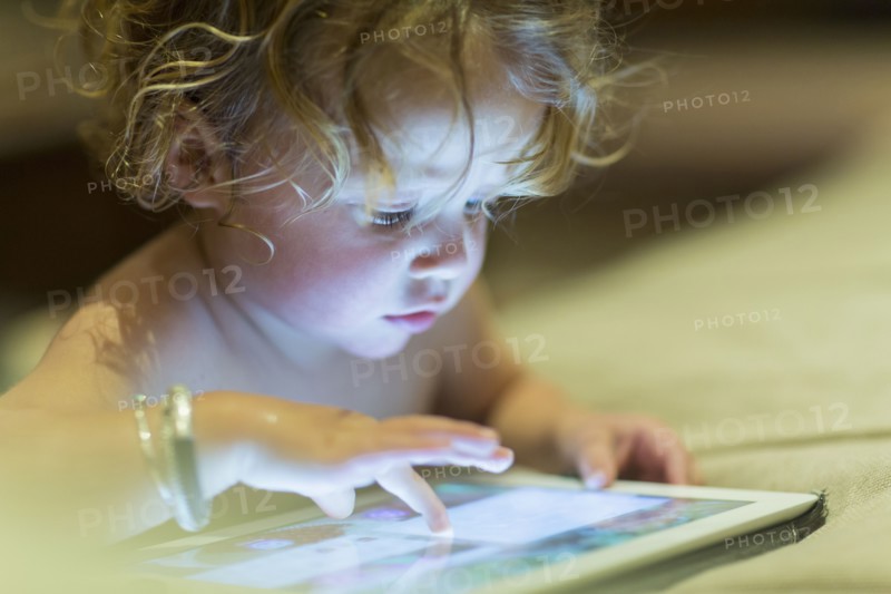 Caucasian baby using digital tablet