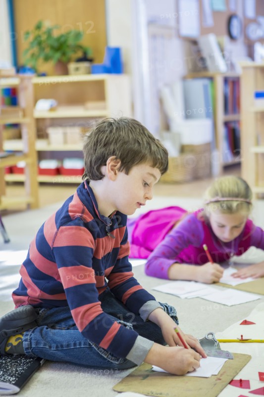 Caucasian children writing in classroom