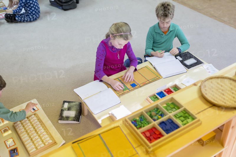 Caucasian children at table in classroom