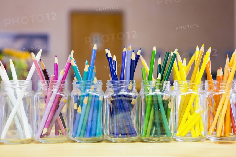 Close up of multicolor pencils organized in jars