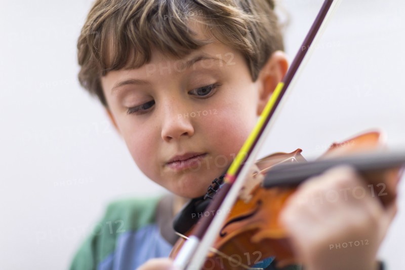 Close up of boy playing violin