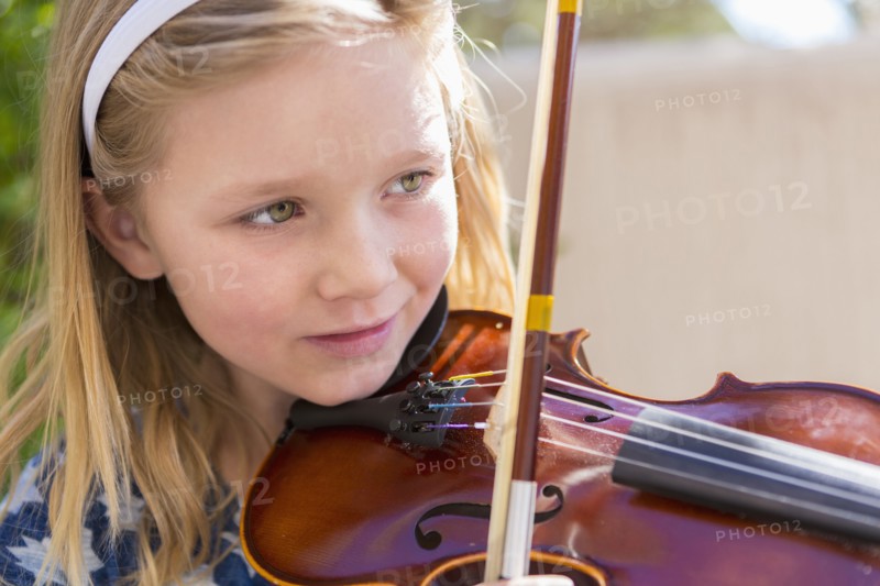 Close up of Caucasian girl playing violin