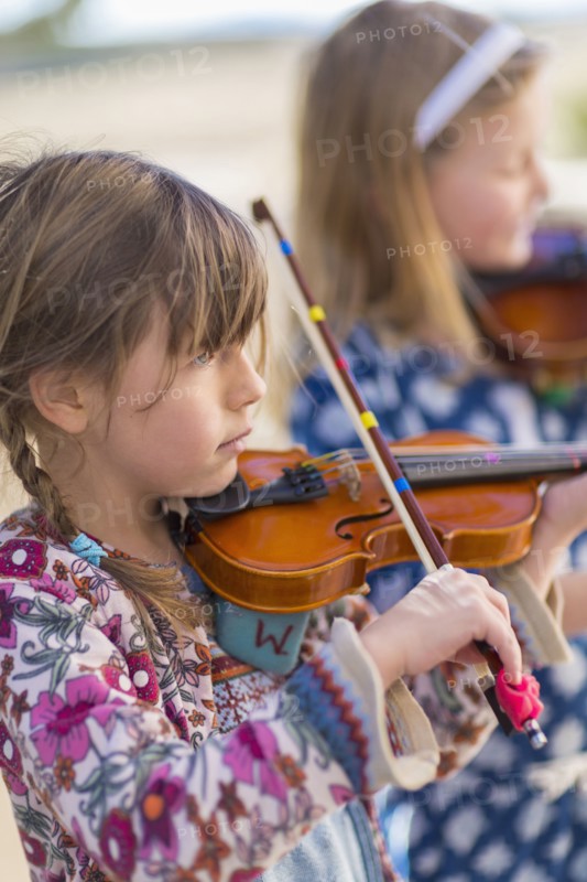 Close up of girls playing violin