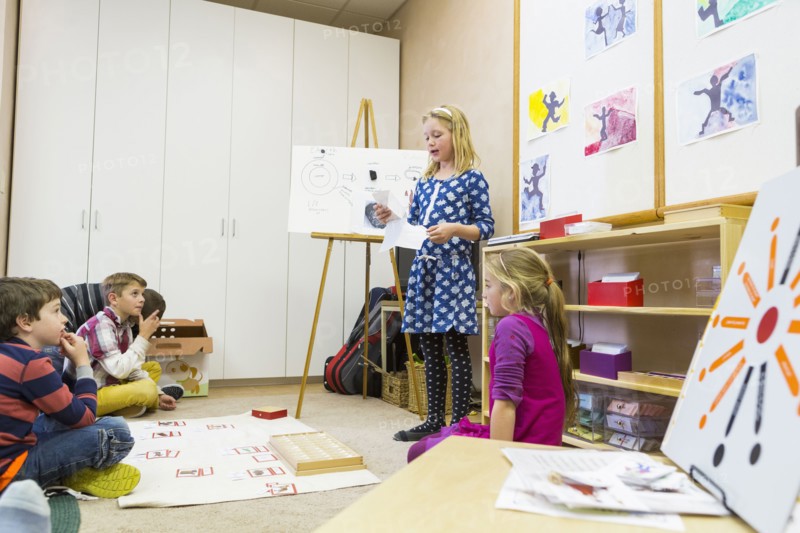 Girl giving presentation to classmates
