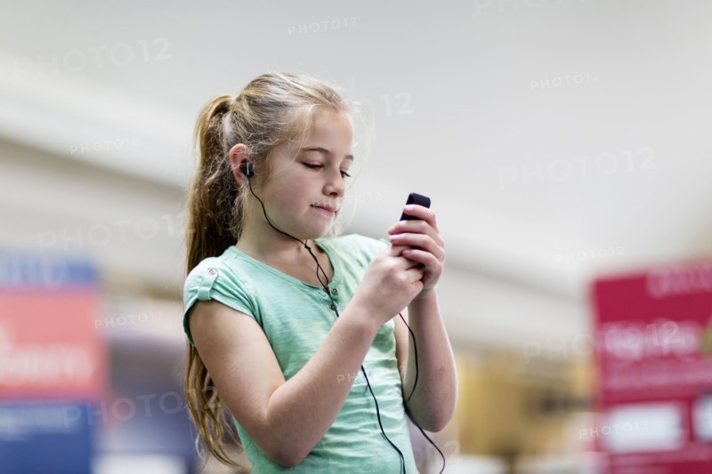 Caucasian girl listening to mp3 player