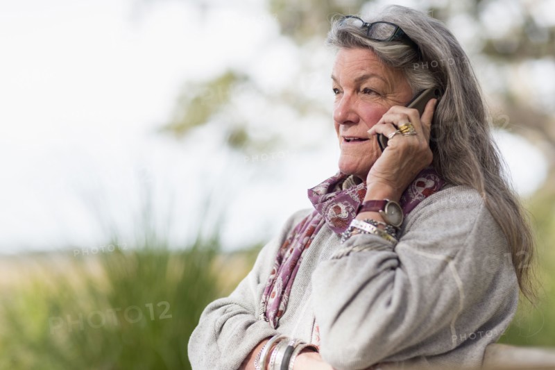 Older Caucasian woman talking on cell phone outdoors