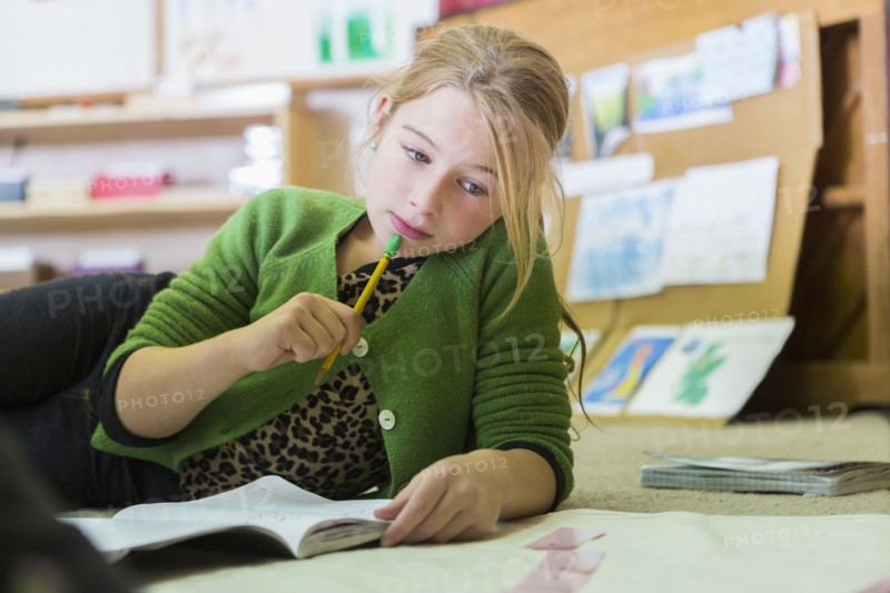 Caucasian girl working in classroom
