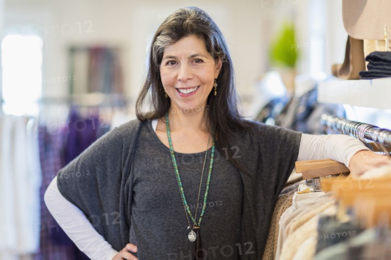 Hispanic small business owner smiling in store