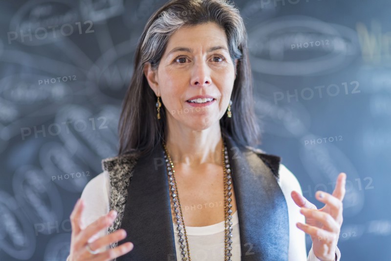 Hispanic businesswoman talking in office