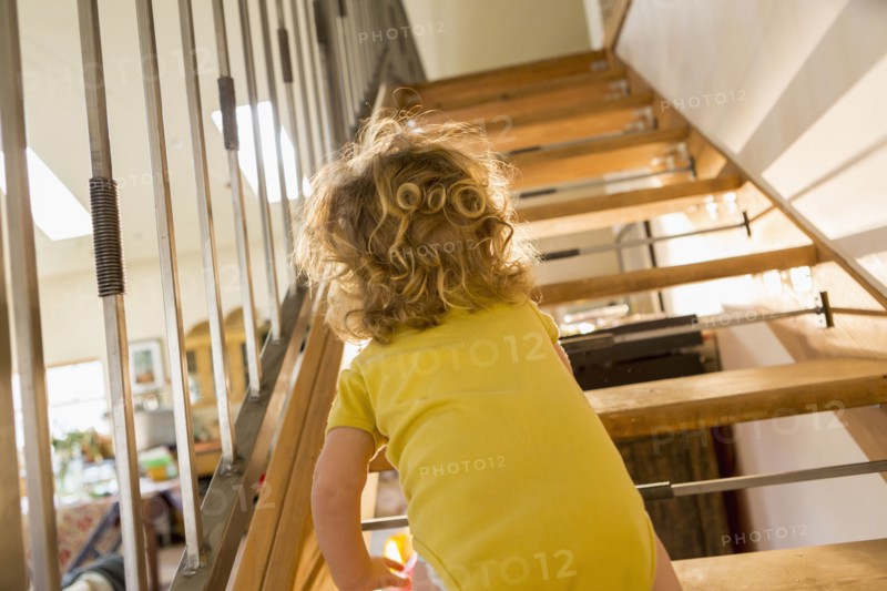 Caucasian baby boy crawling up stairs