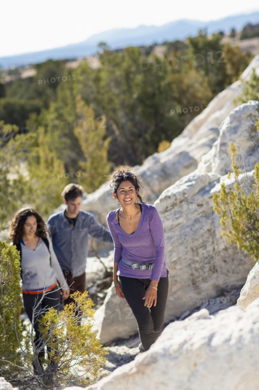 Hikers climbing rocky hillside