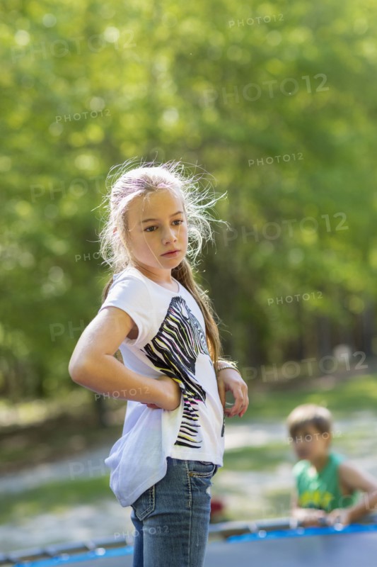 Caucasian girl standing on trampoline