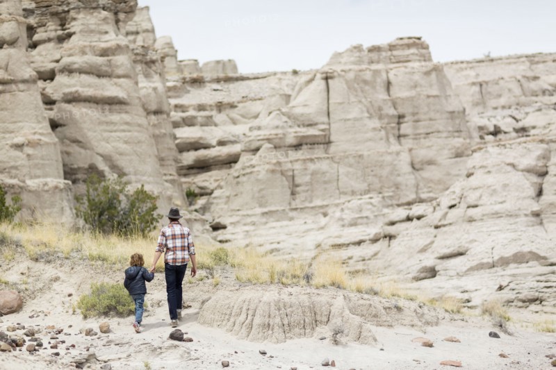 Father and son exploring desert rock formations