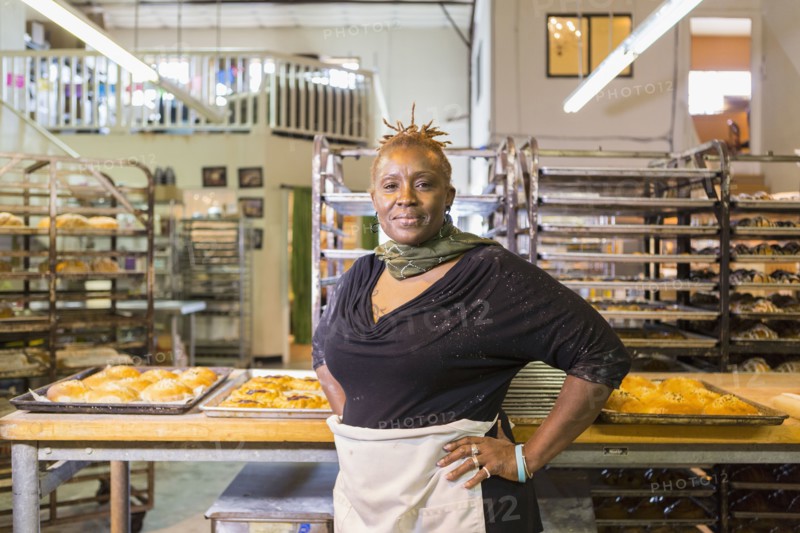 Black baker standing in bakery kitchen