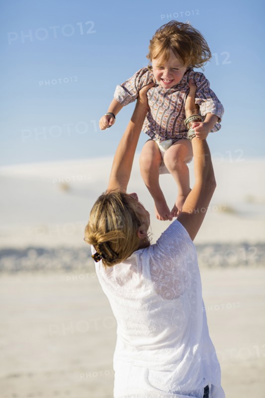 Caucasian mother and son playing in desert
