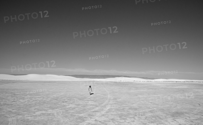 Caucasian girl lost in desert landscape