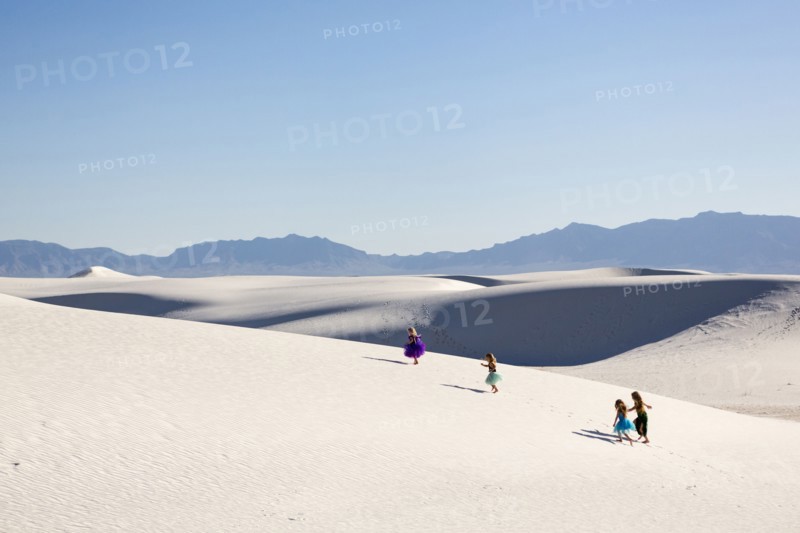 Girls walking on desert sand dunes