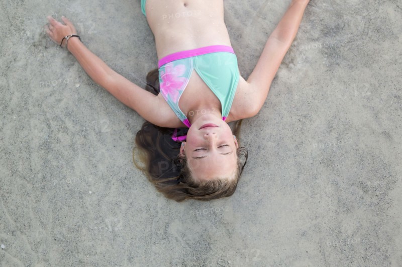 Caucasian girl napping on beach