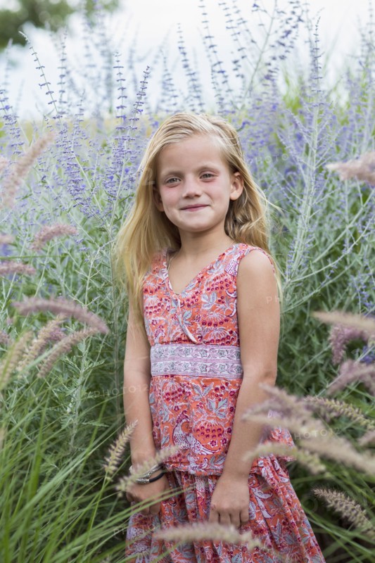 Caucasian girl smiling in tall grass