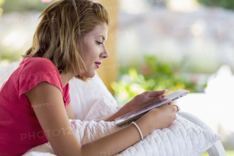 Mixed race woman using digital tablet