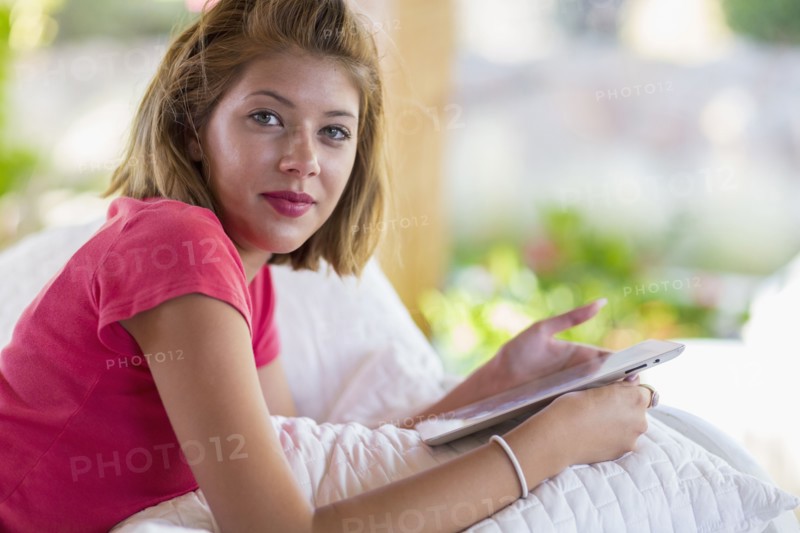 Mixed race woman using digital tablet