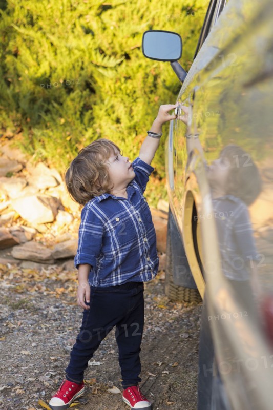 Caucasian boy opening car door