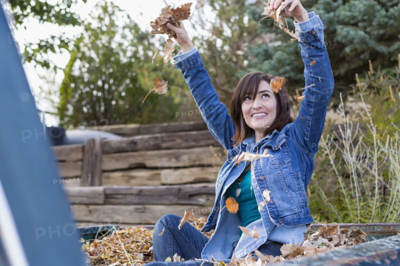 Hispanic woman playing in truck bed