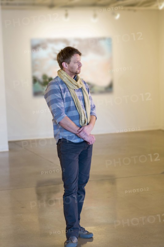 Caucasian man standing in art gallery
