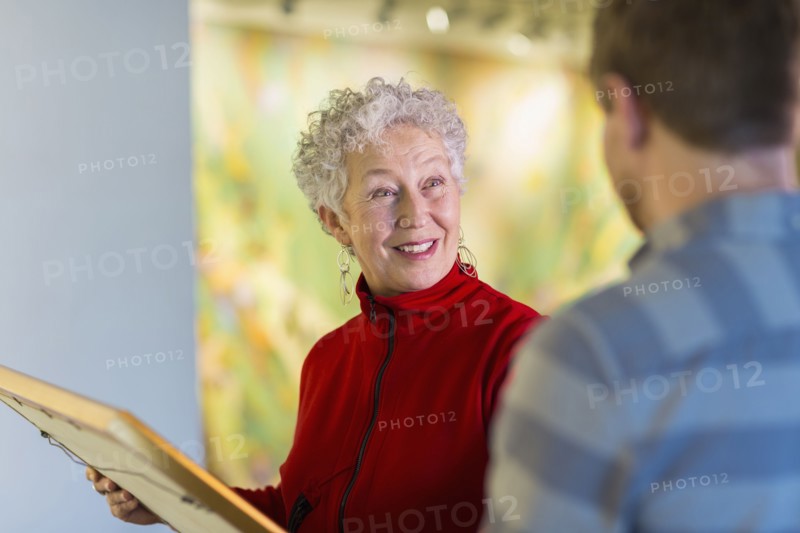 People talking in art gallery