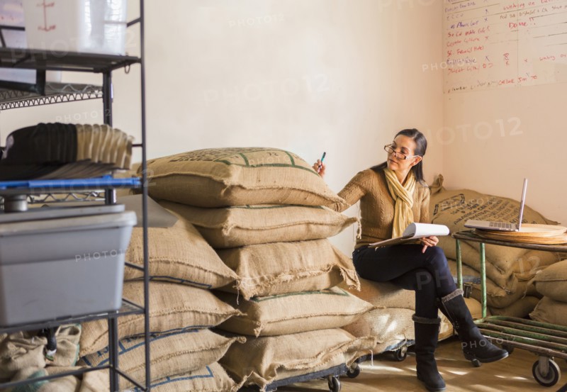 Hispanic business owner checking inventory