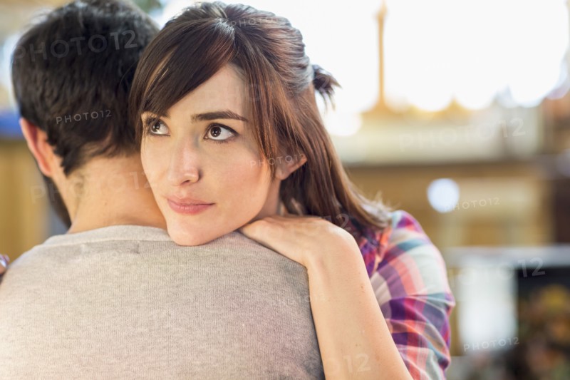 Hispanic woman hugging boyfriend