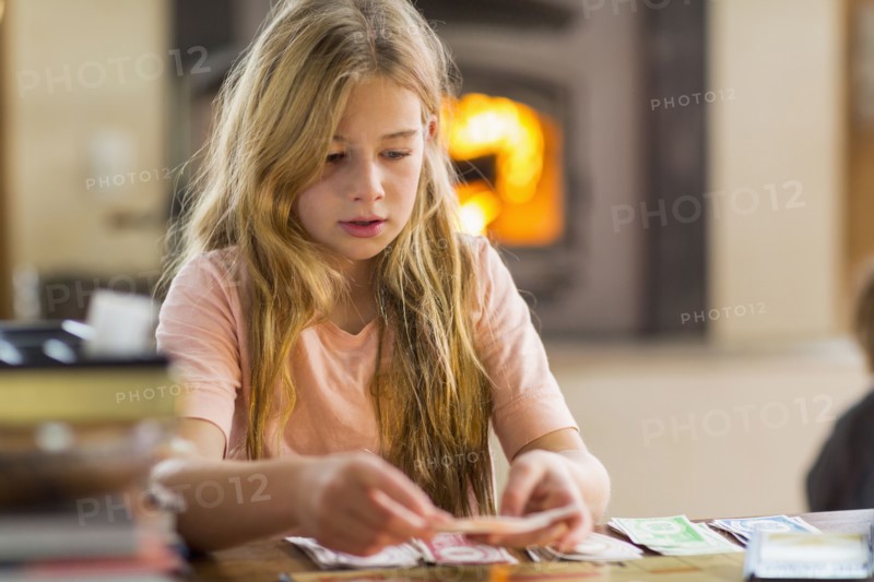 Caucasian girl playing cards