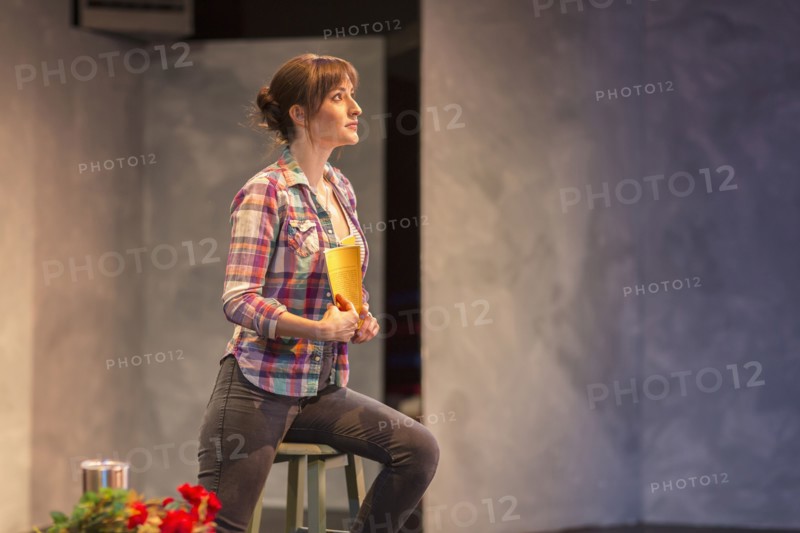Hispanic actress rehearsing on theater stage