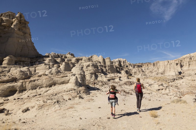 Caucasian mother and children hiking in desert