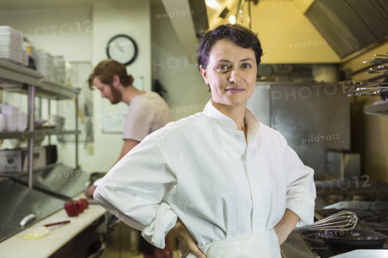 Caucasian chef smiling in restaurant kitchen