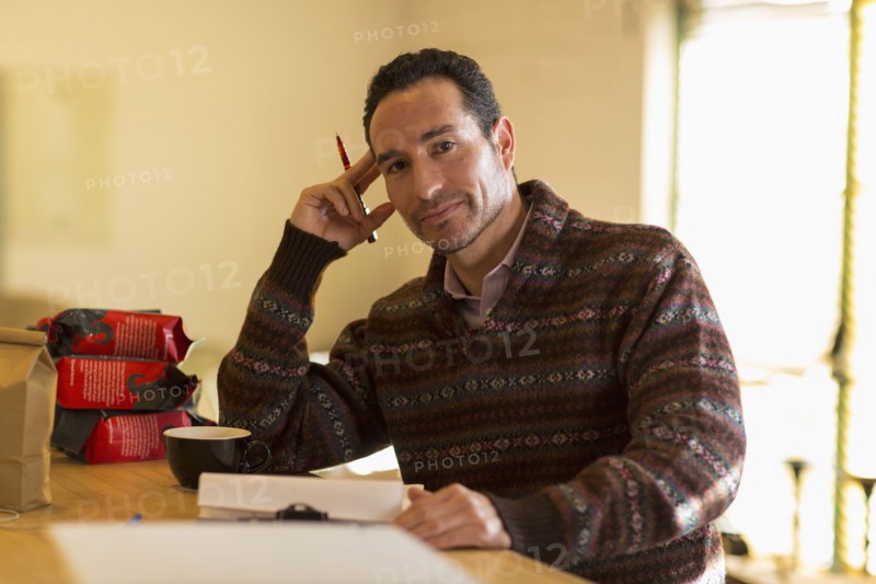 Hispanic entrepreneur taking inventory in store