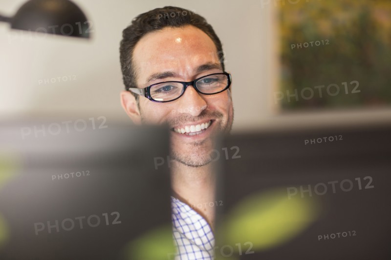 Hispanic businessman using computer in office