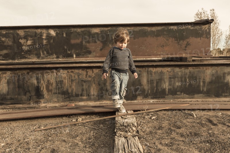 Caucasian boy walking on wall