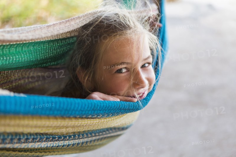Smiling Caucasian girl laying in hammock