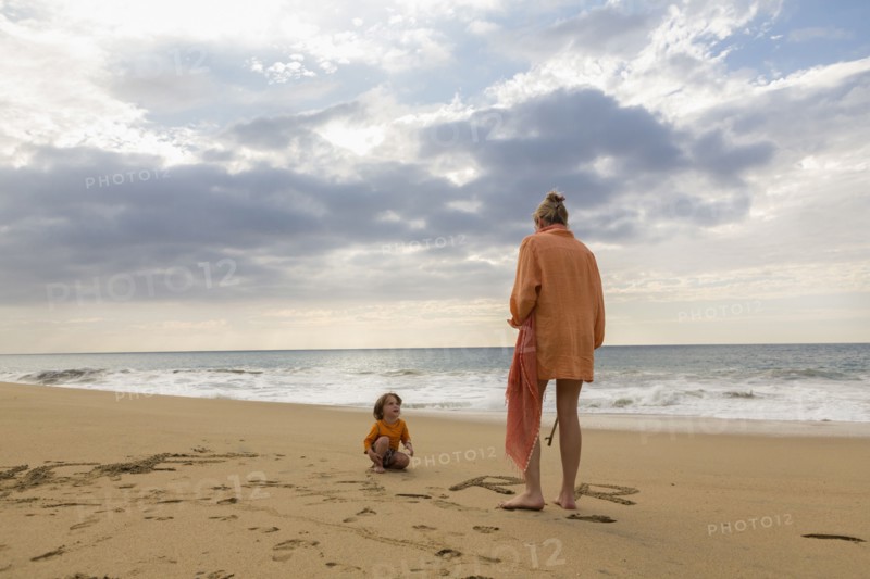 Caucasian mother and son on beach