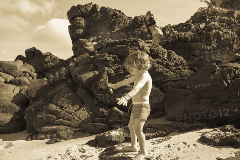 Caucasian brother and sister playing on beach