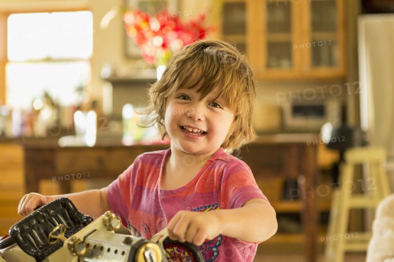 Caucasian boy holding vintage toy car