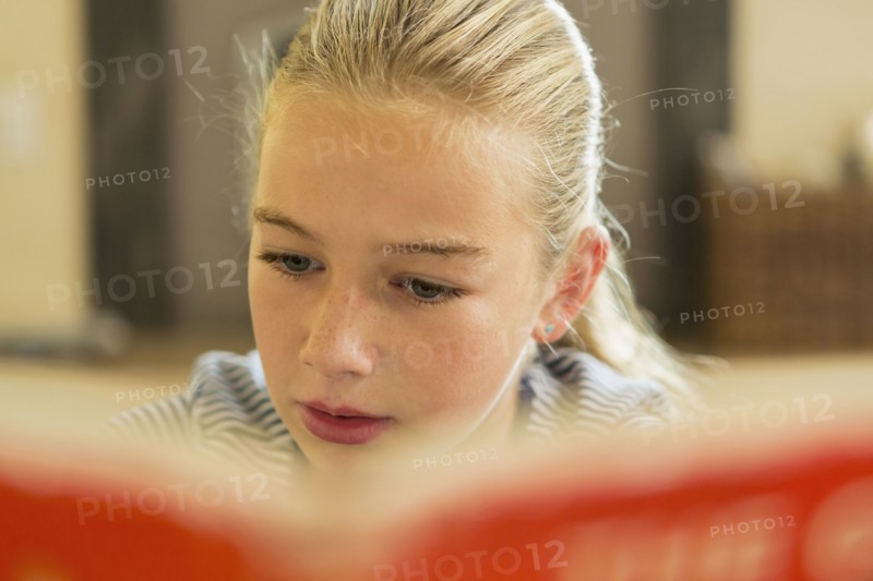 Caucasian girl reading book