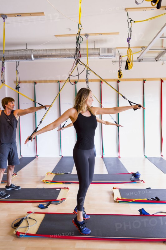 People using resistance bands in gymnasium