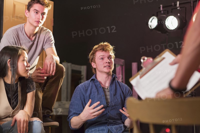 Student talking to teacher in theater class