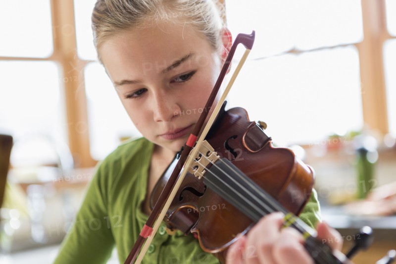Close up of Caucasian girl playing violin